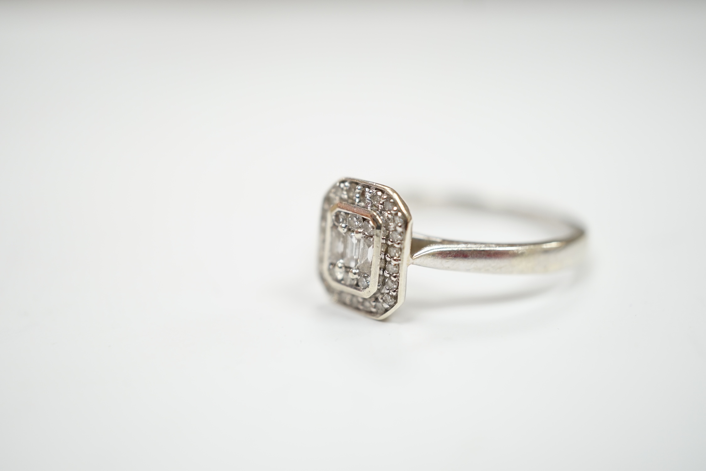 A modern 9ct white gold and diamond set cluster ring, size N, gross weight 2.5 grams.